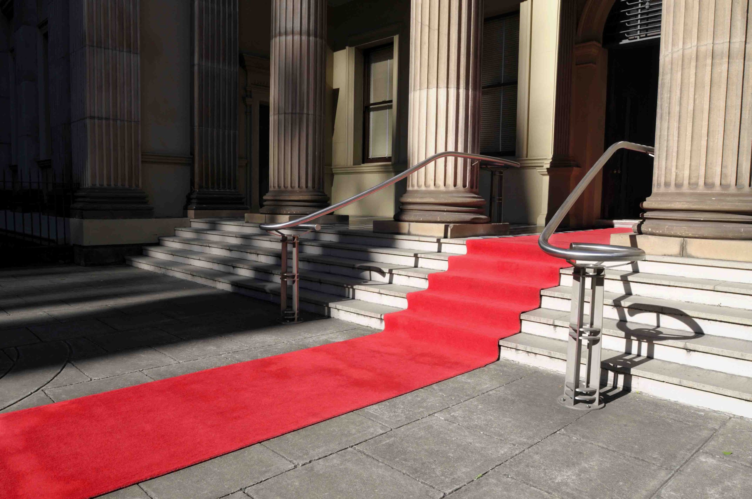 Red carpet laid in front of a luxury hotel building